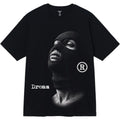 Black t-shirt with a graphic of a person wearing a balaclava and the word 'Dream' on a white background