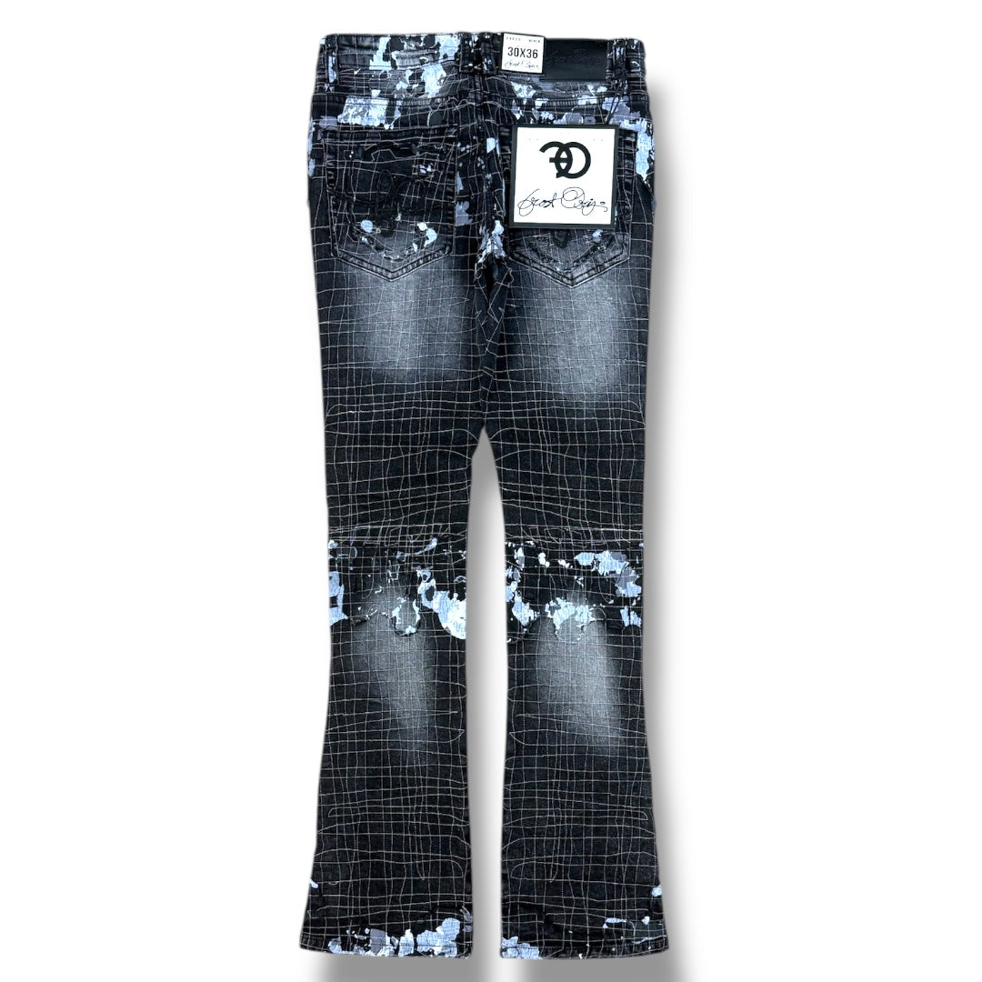 A pair of black and white grid-patterned flare jeans with distressed and paint-splatter details, shown flat against a white background. A white brand label for 'Good Guys' is attached to the back pocket.