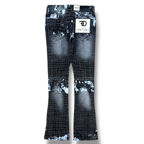 A pair of black and white grid-patterned flare jeans with distressed and paint-splatter details, shown flat against a white background. A white brand label for 'Good Guys' is attached to the back pocket.