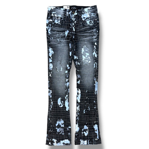 Distressed flare jeans featuring a black and blue grid pattern with abstract splatter and tear details, shown flat against a white background.