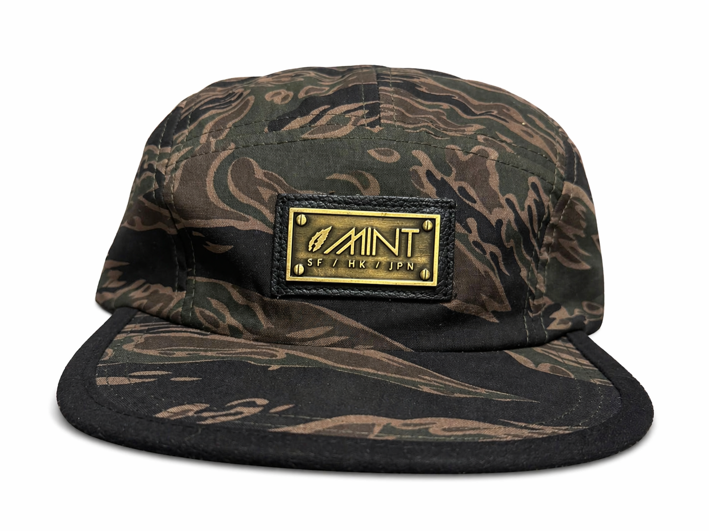 Camouflage cap with a gold logo on a white background