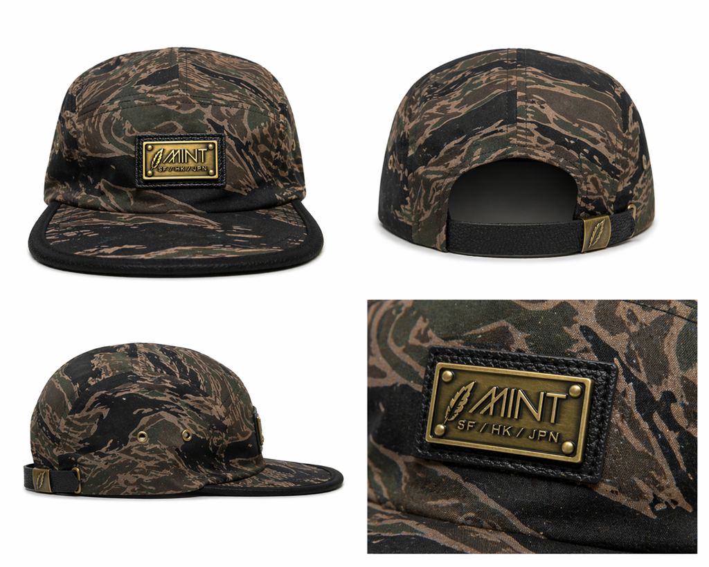 Camouflage cap with a gold label on a white background