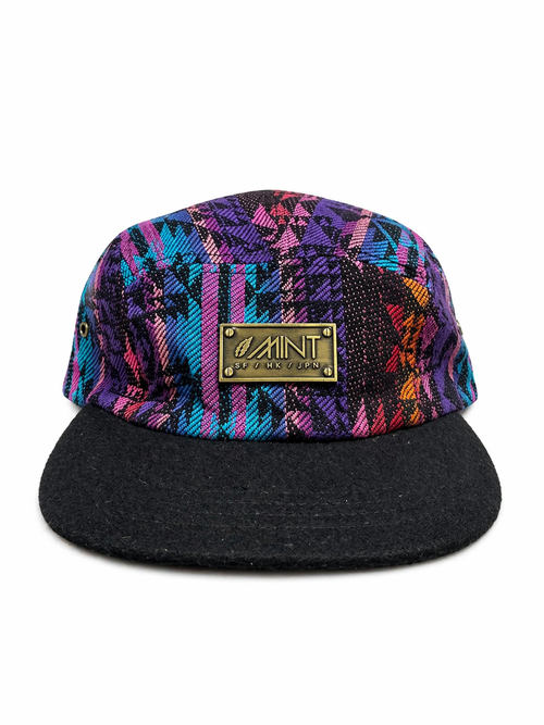 Colorful patterned cap with a black brim and gold logo on a white background