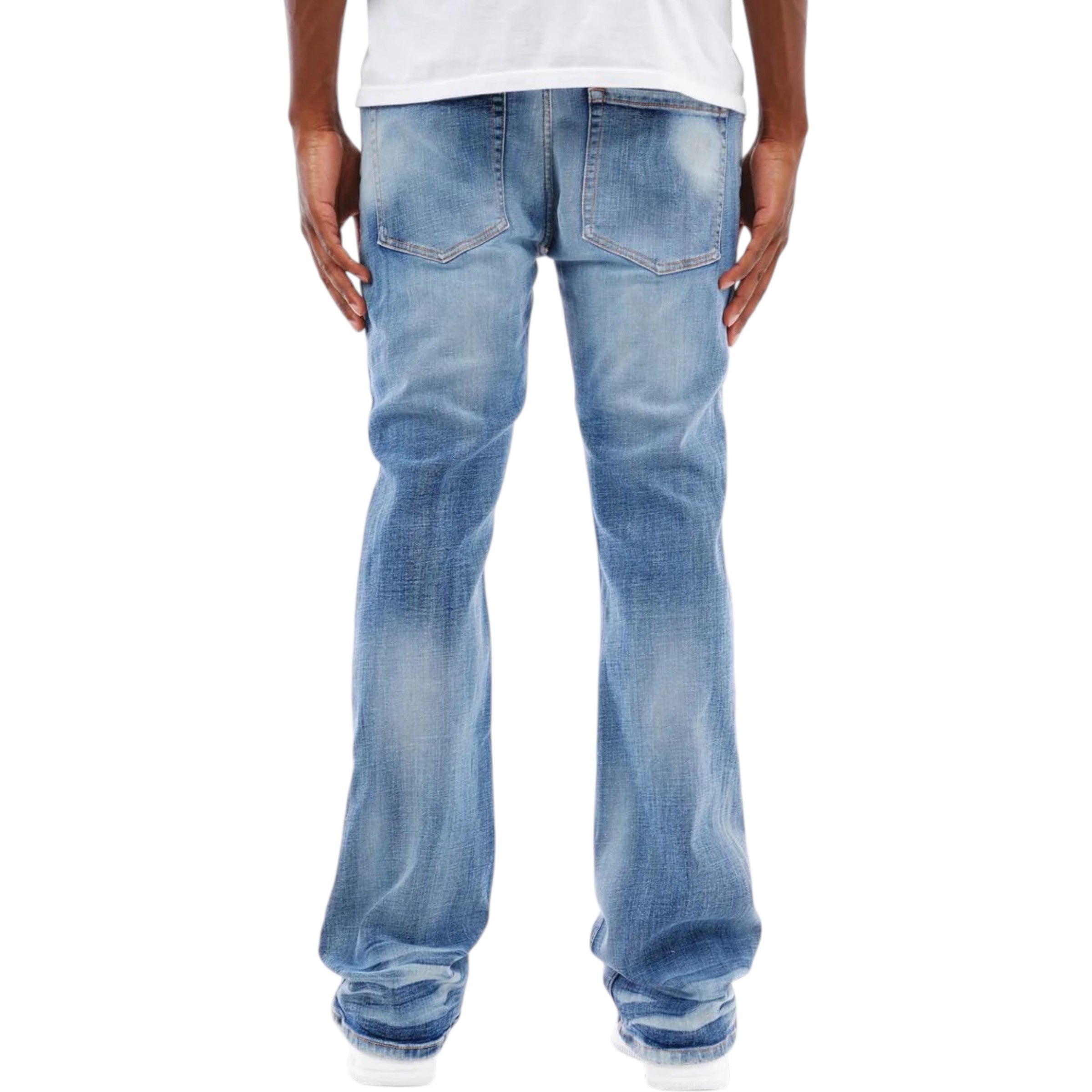 Light blue  flared stack jeans worn by a person on a white background