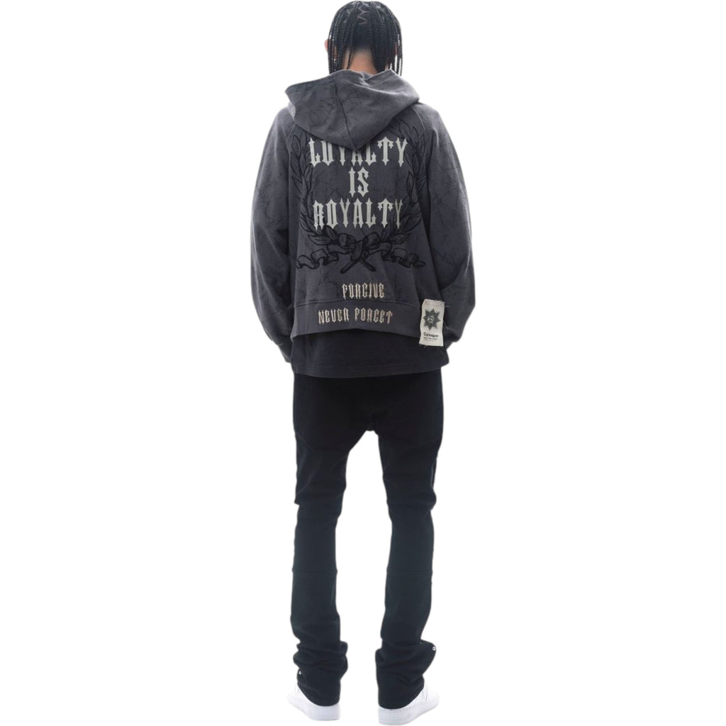 Person wearing a black hoodie with text on the back against a white background