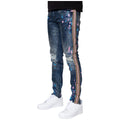 Blue jeans with colorful splatter design and striped side panels worn by a person on a white background