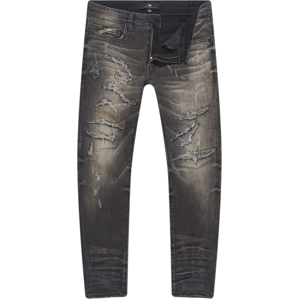 Distressed black jeans on a white background