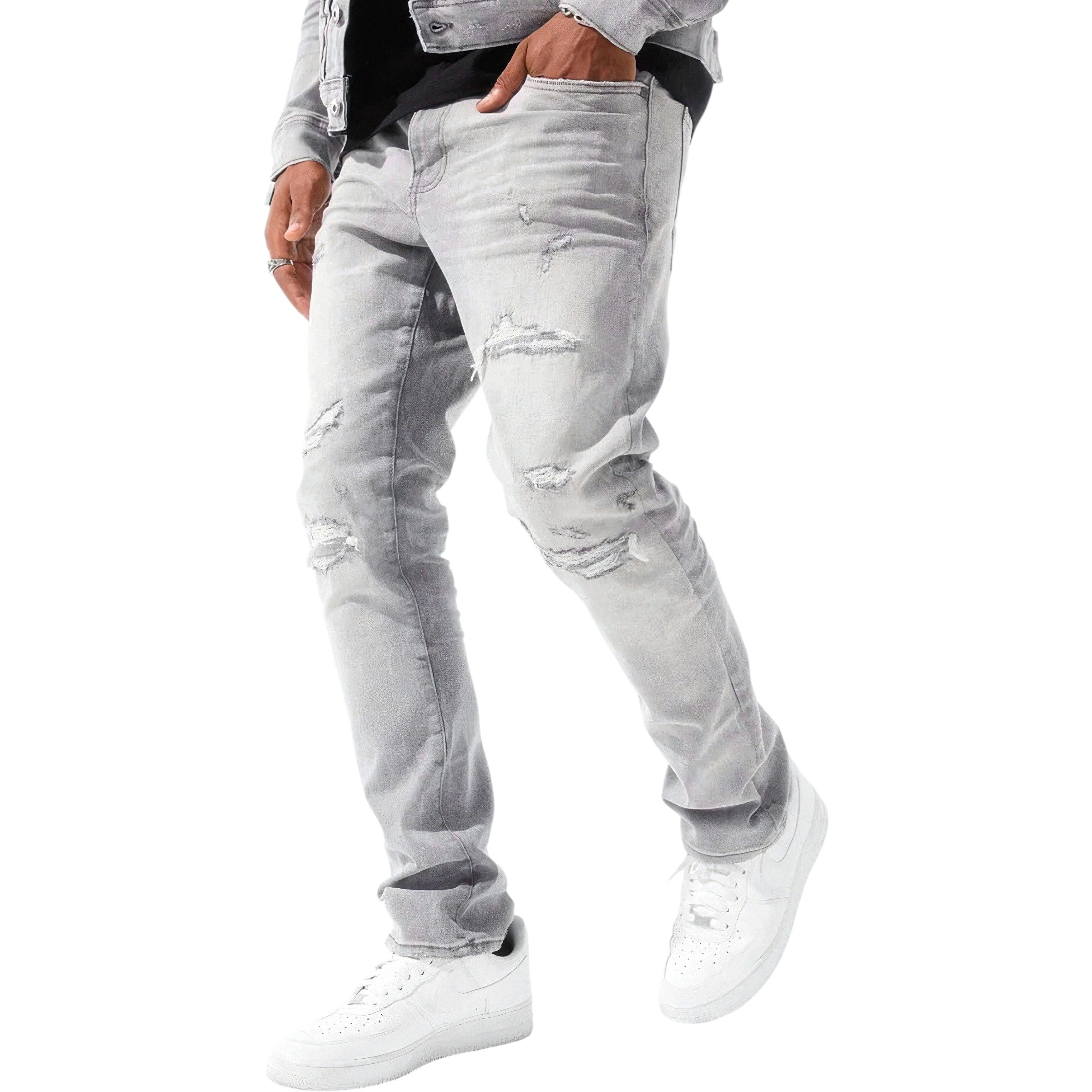 Person wearing light gray distressed jeans and white sneakers on a white background straight fit jeans