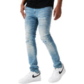 Light blue distressed jeans worn by a person on a white background