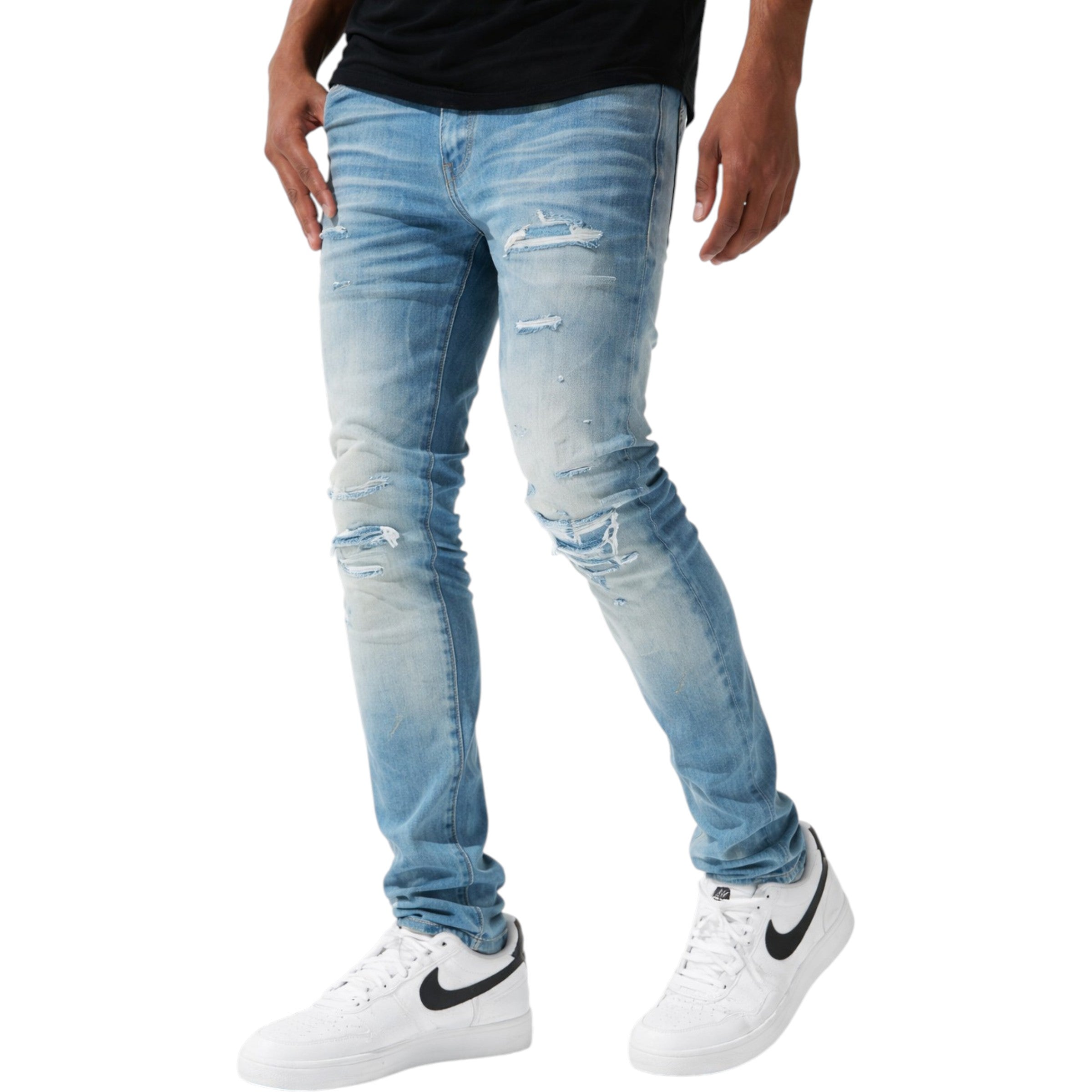 Light blue distressed jeans worn by a person on a white background