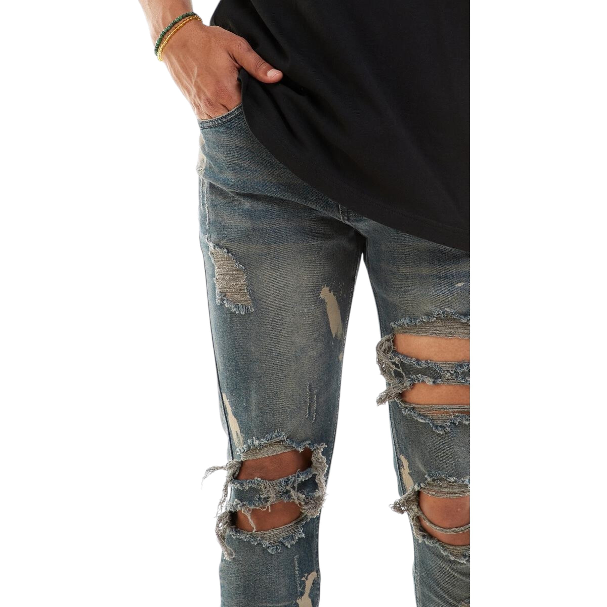 Ripped jeans worn by a person on a white background