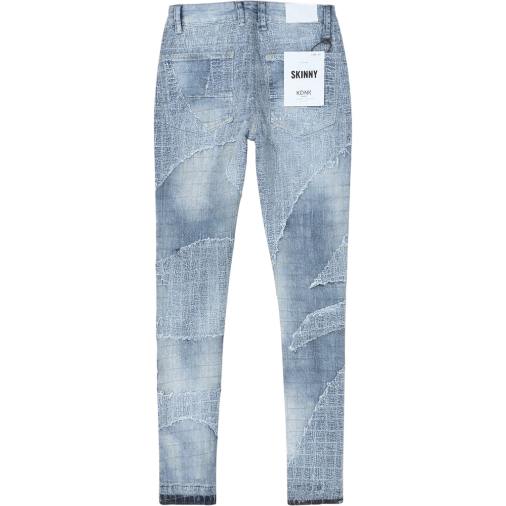 Blue jeans with a 'Skinny' label on a white background