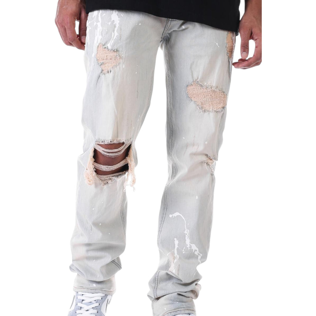 Light gray distressed jeans worn by a person on a white background