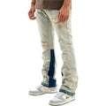 Light-colored distressed jeans with blue patches worn by a person, paired with white sneakers featuring a logo. stacked flared jeans