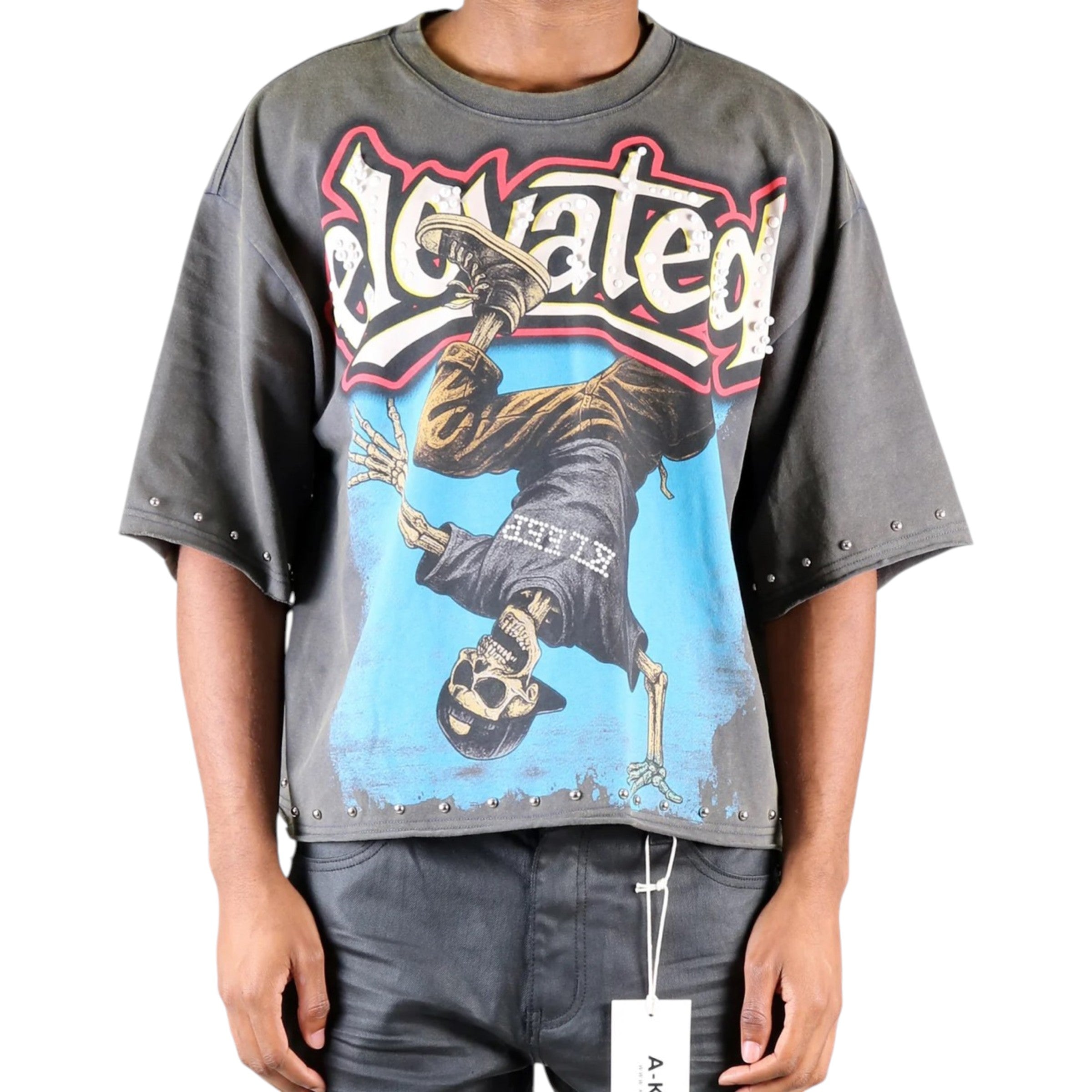 Person wearing a graphic t-shirt with a design and text on a white Cropped oversized background