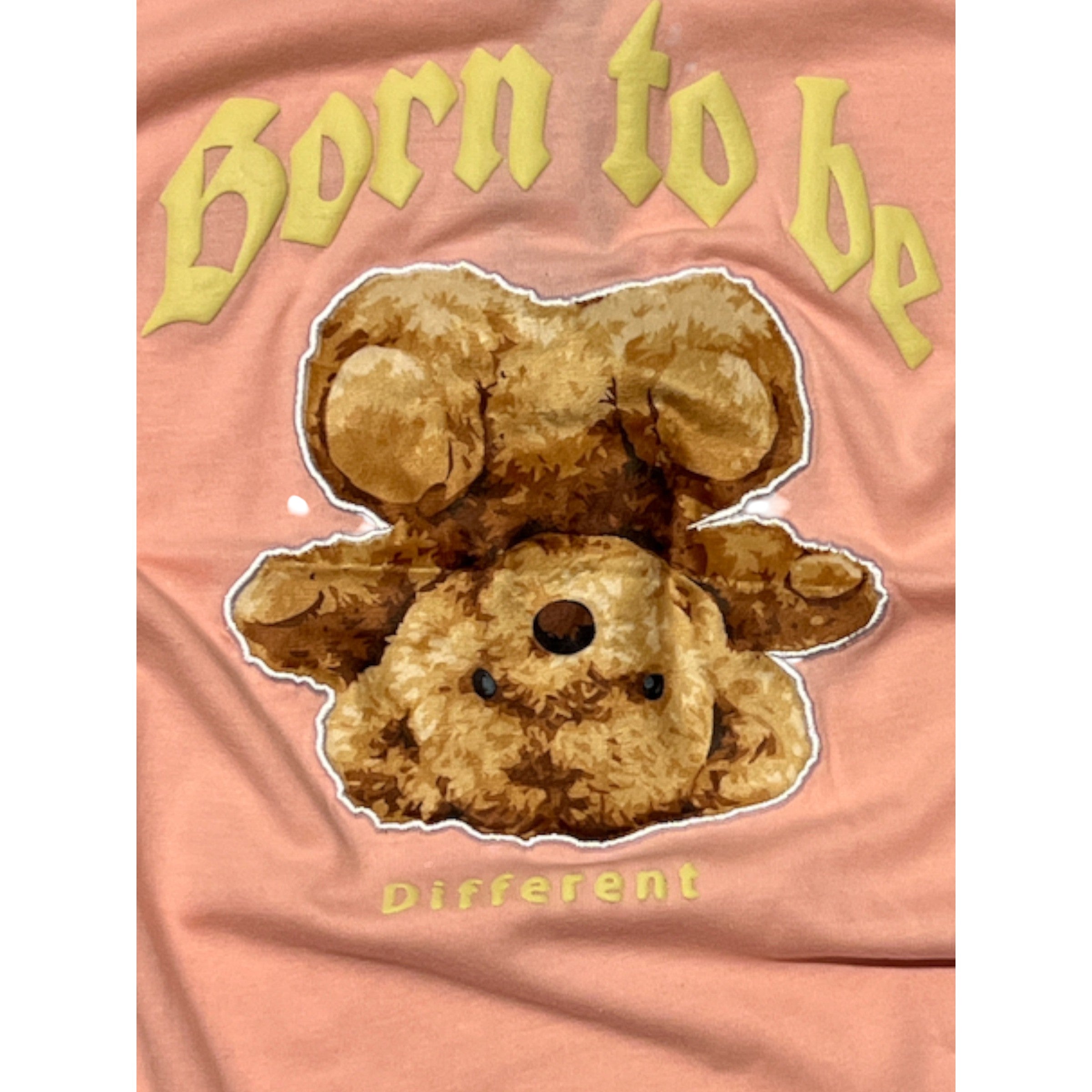 Pink t-shirt with a brown teddy bear graphic and 'Born to be Different' text.