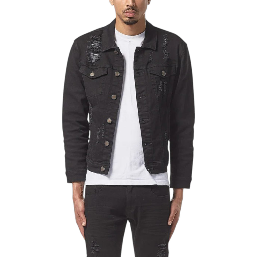 Person wearing a black distressed denim jacket on a white background