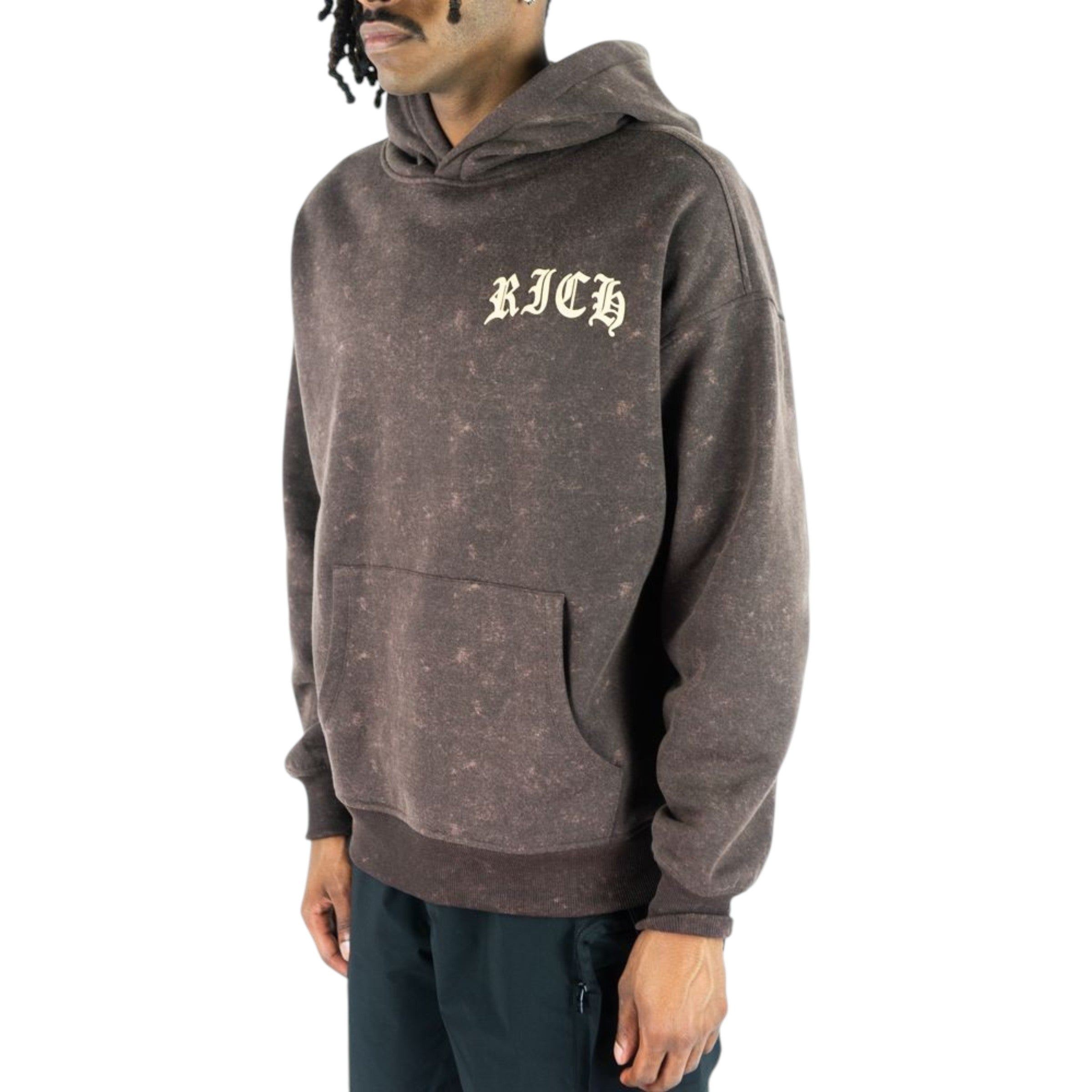 Person wearing a brown hoodie with 'RICH' text on a white background