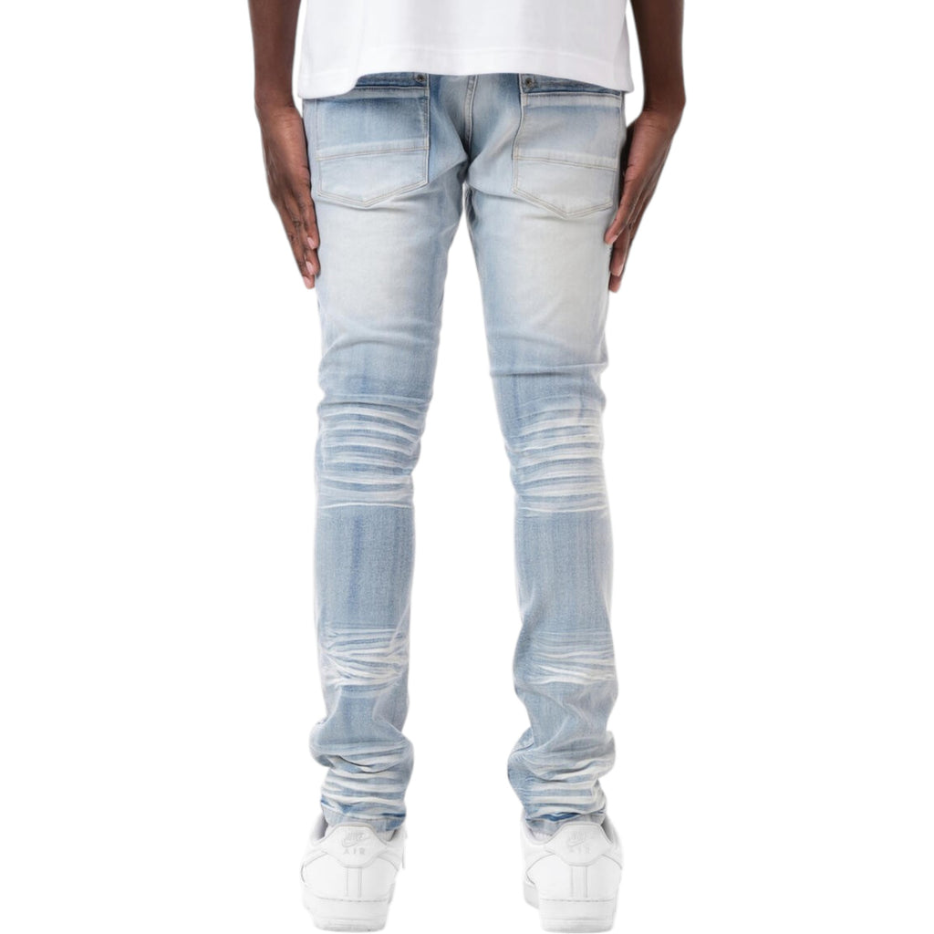 Light blue distressed jeans worn by a person on a white background