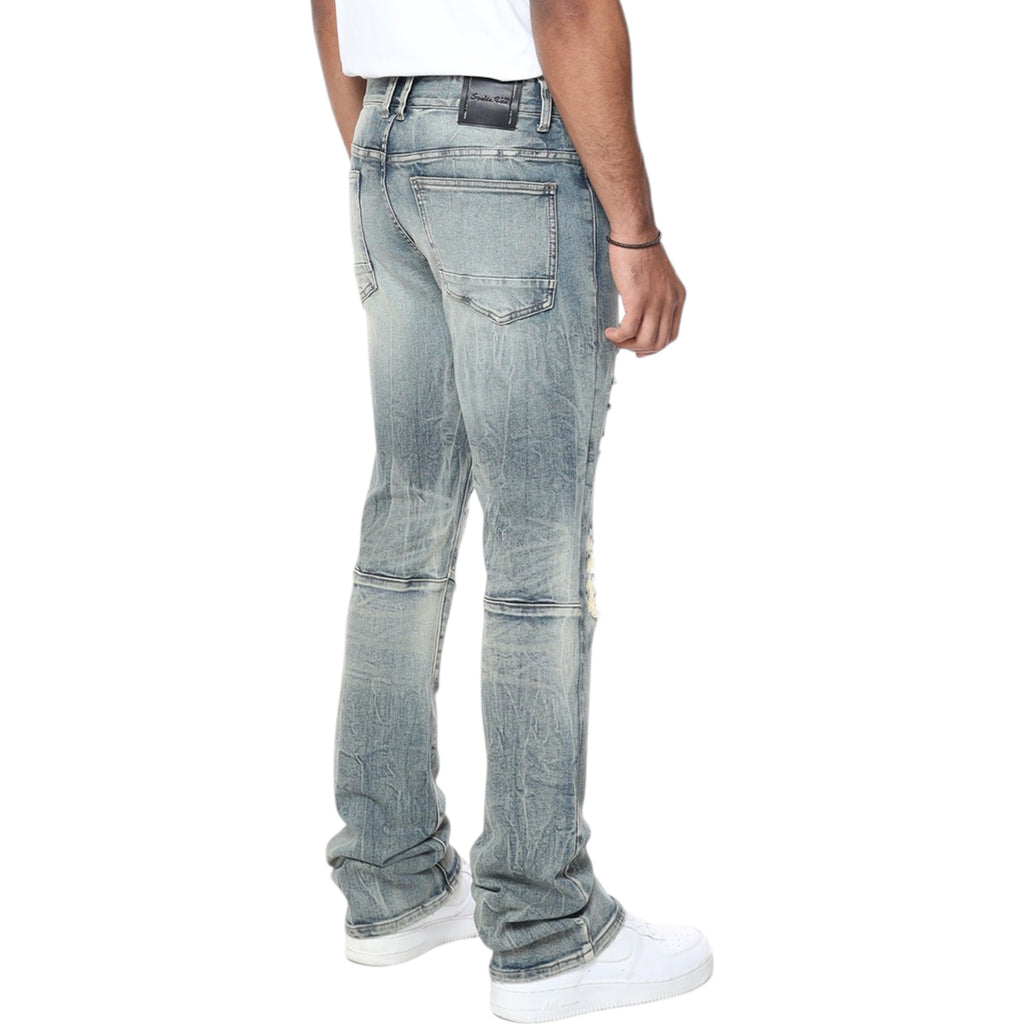 Person wearing light blue jeans on a white background