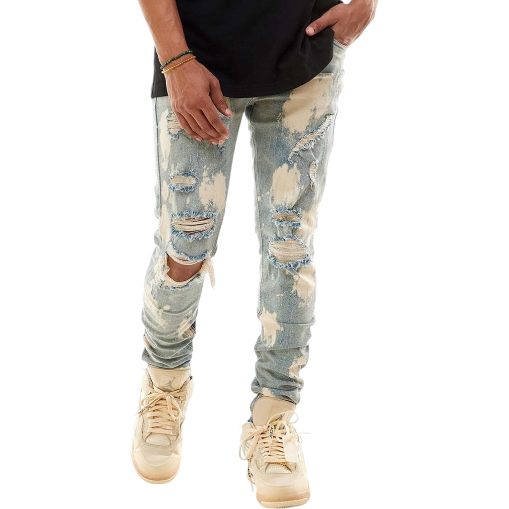 Ripped light blue jeans worn by a person on a white background