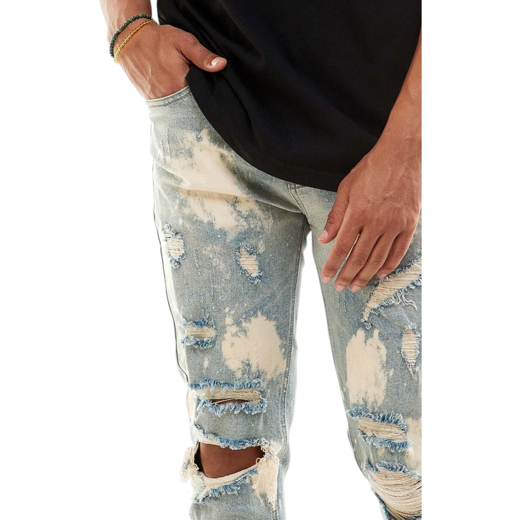 Distressed light blue jeans worn by a person on a white background