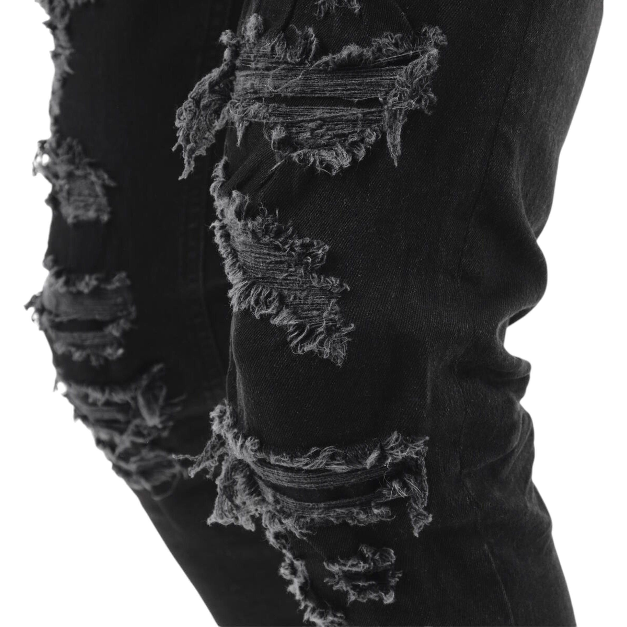 Black distressed jeans with a close-up of the ripped design on a white background