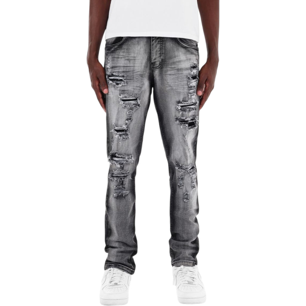 Person wearing distressed gray jeans on a white background