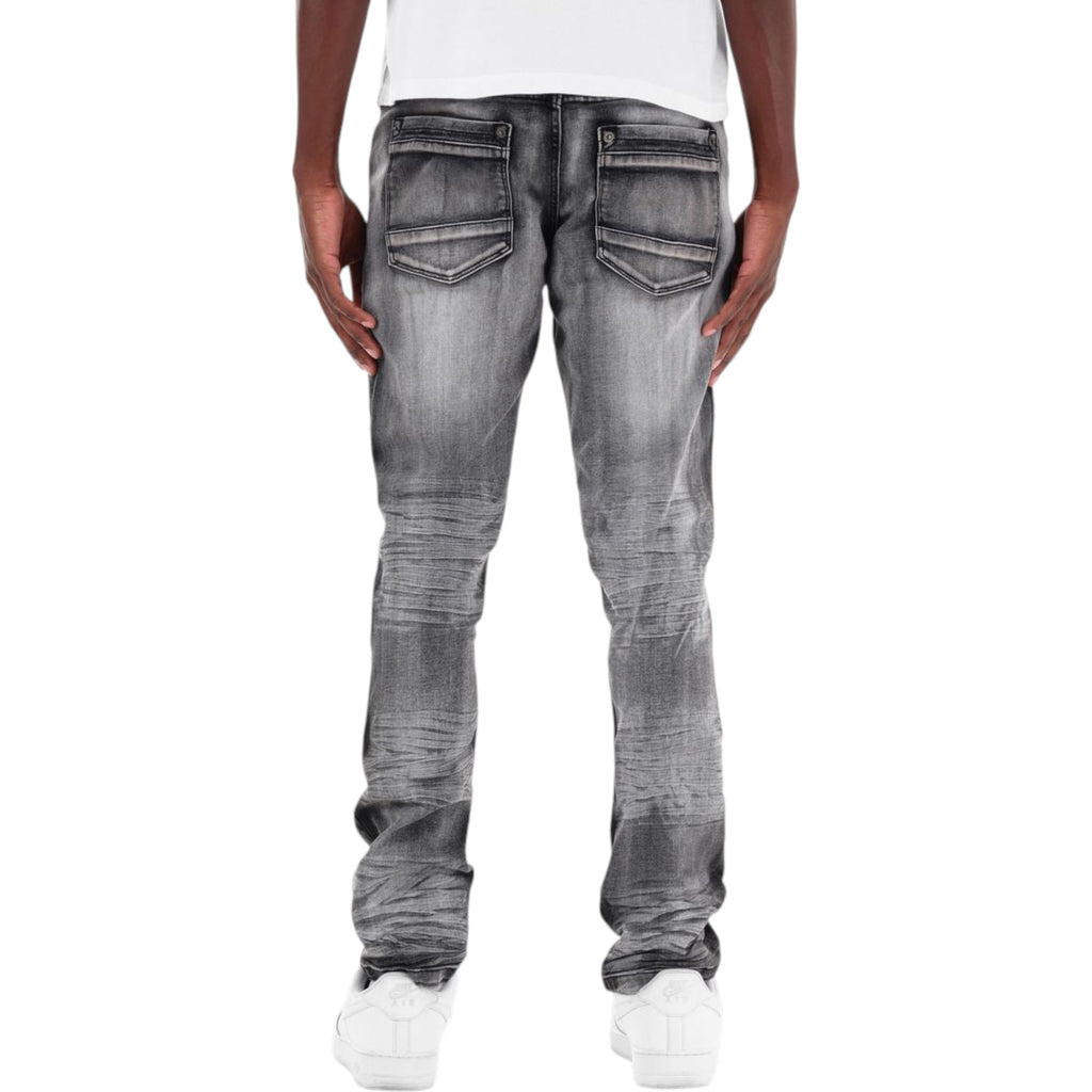 Person wearing gray distressed jeans on a white background