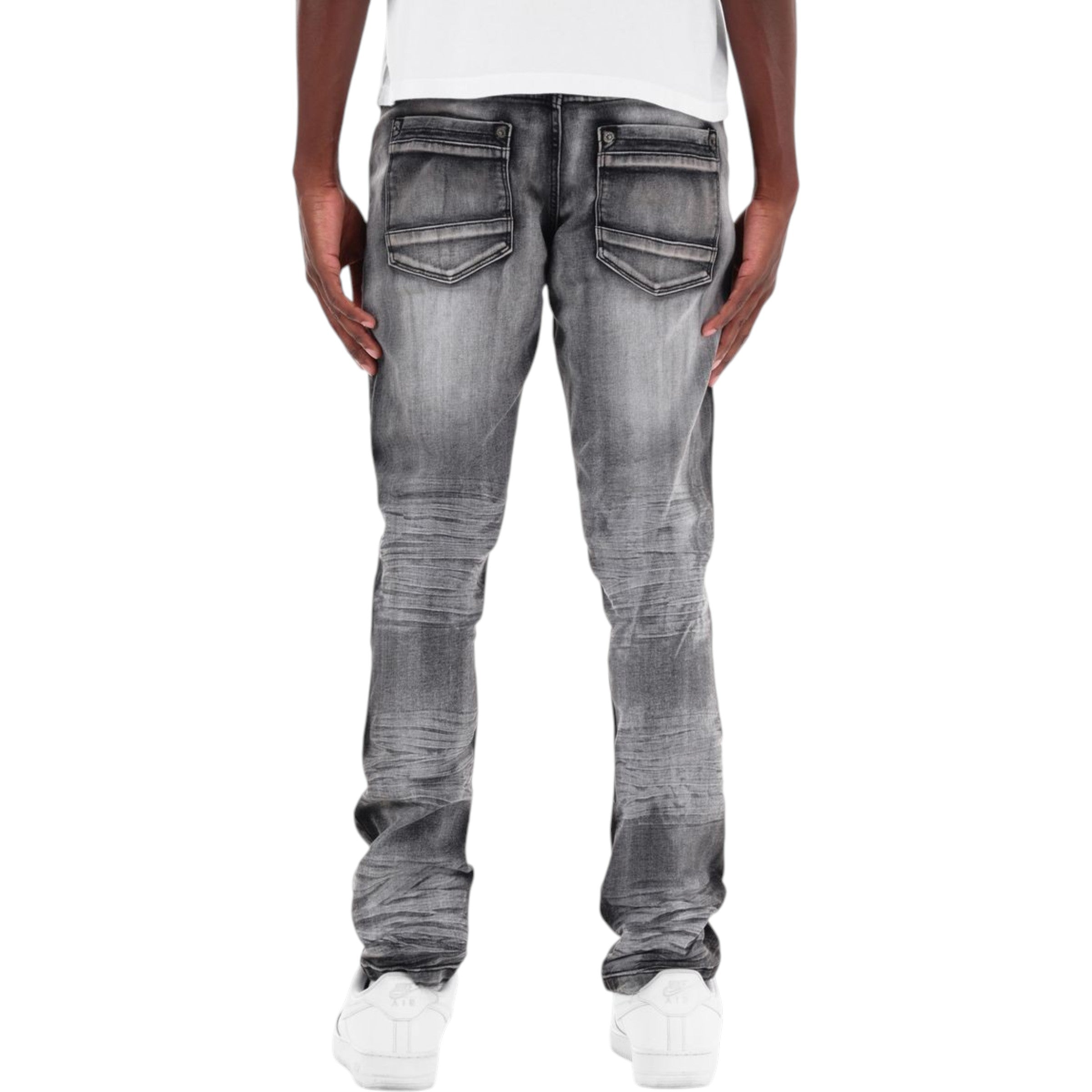 Person wearing gray distressed jeans on a white background