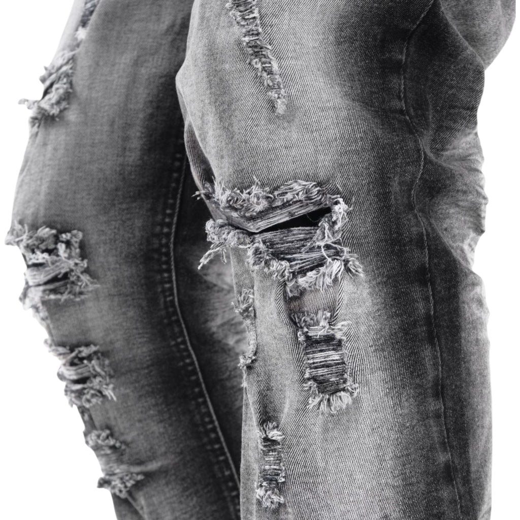 Ripped denim jeans with a focus on the distressed details.