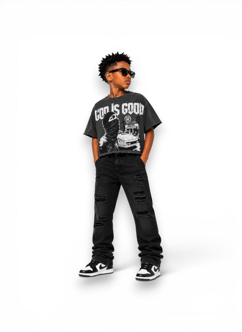Child wearing a graphic t-shirt and black jeans on a white background By dubforty.