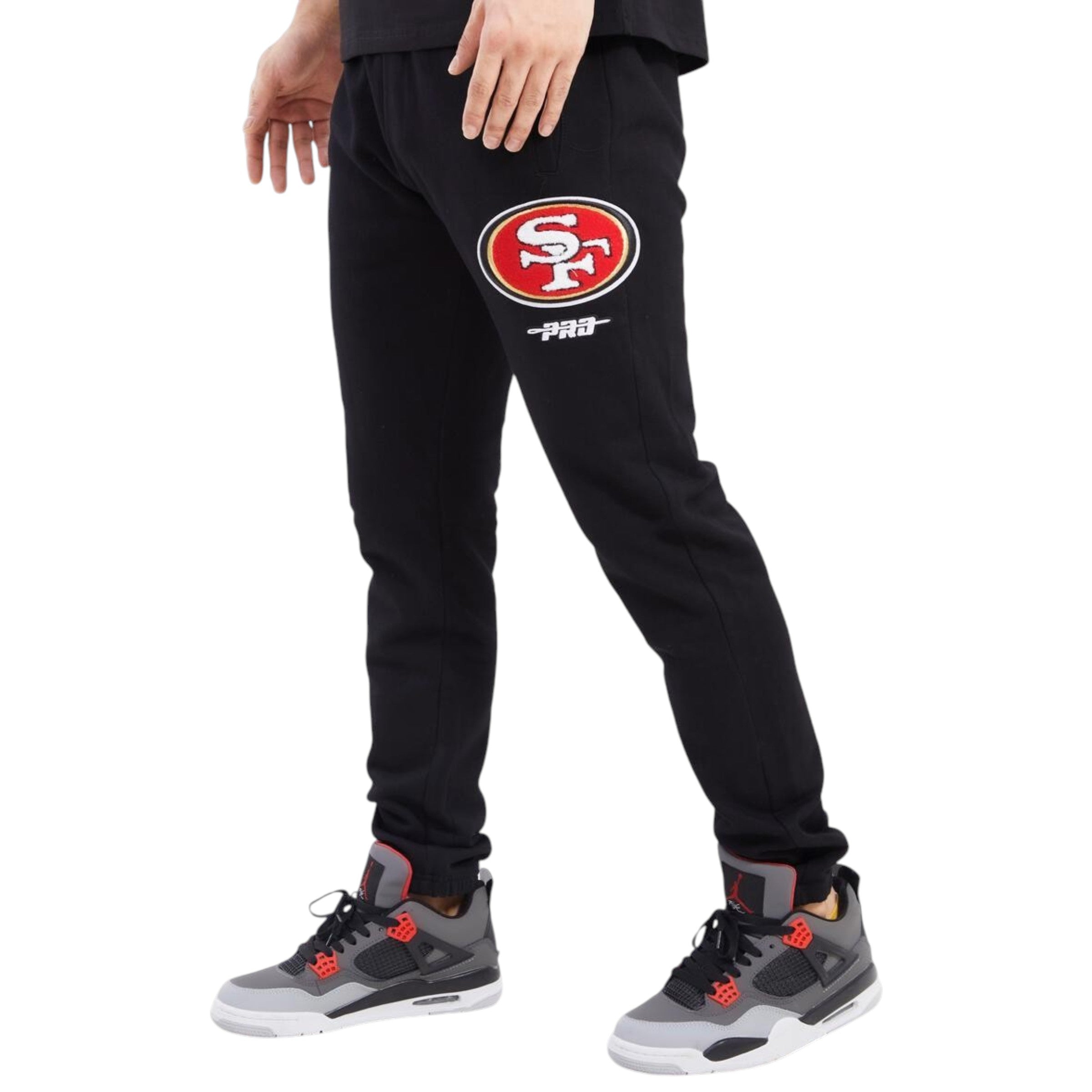 Black sweatpants with a logo worn by a person on a white background