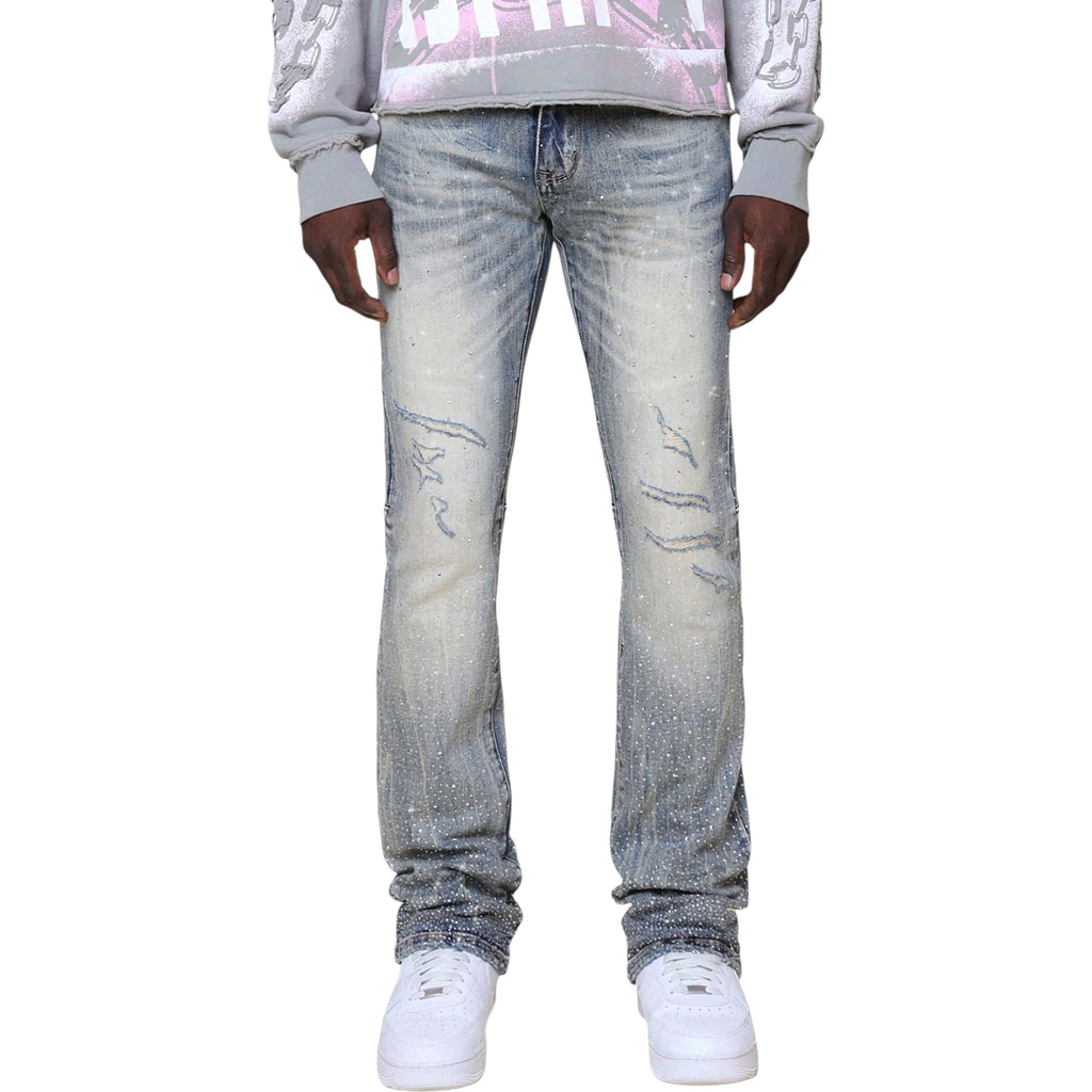 Person wearing light blue jeans and a gray sweatshirt on a white Smoke Rise 'All Rhinestone' Stacked Flare Denim (Mojave Blue) JP25536background
