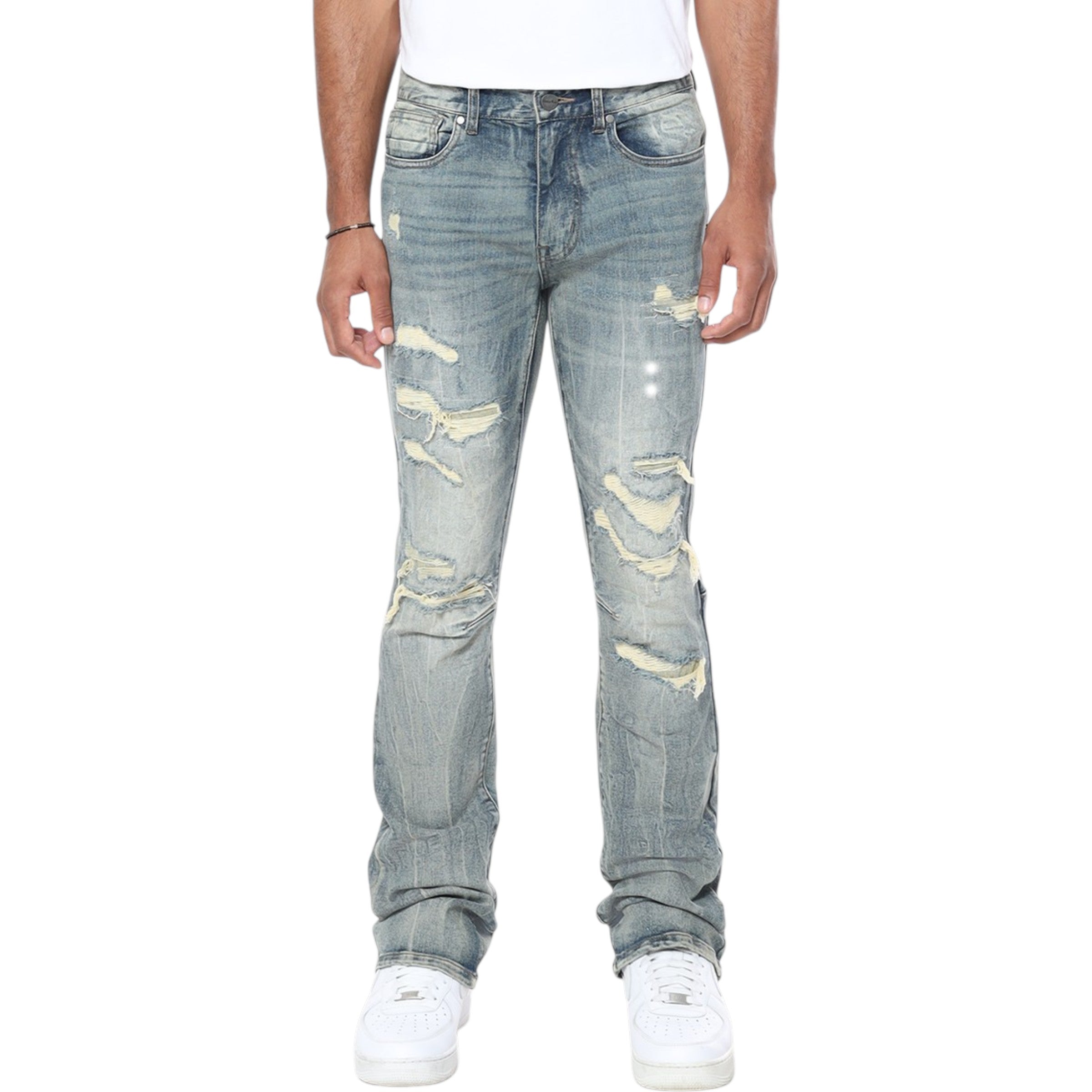 Distressed light blue jeans worn by a person on a white background