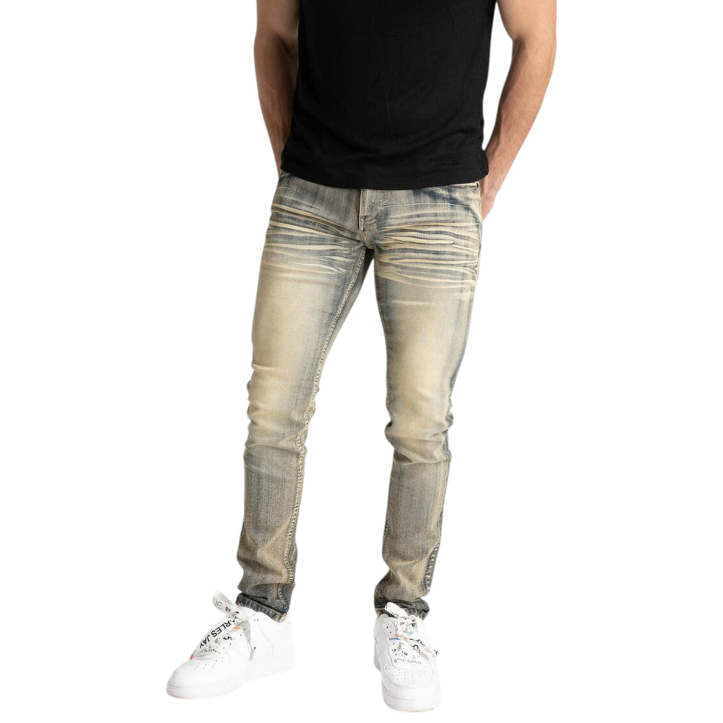 Person wearing light-colored distressed jeans and white sneakers on a white background