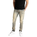 Person wearing light-colored distressed jeans and white sneakers on a white background