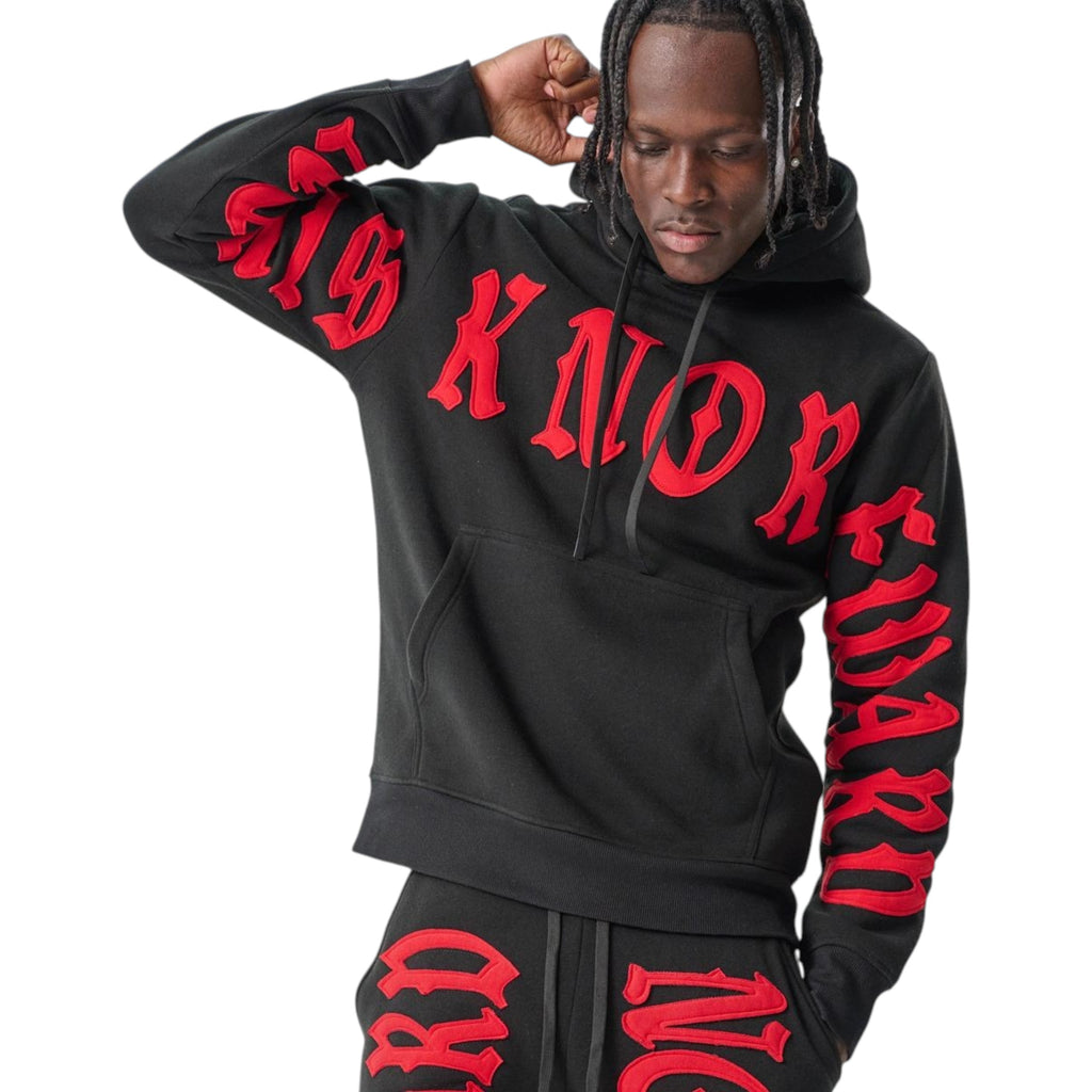 Person wearing a black hoodie and pants with red text on a white background Spark 'No Risk No Reward' Hoodie (Black/Red) S5201