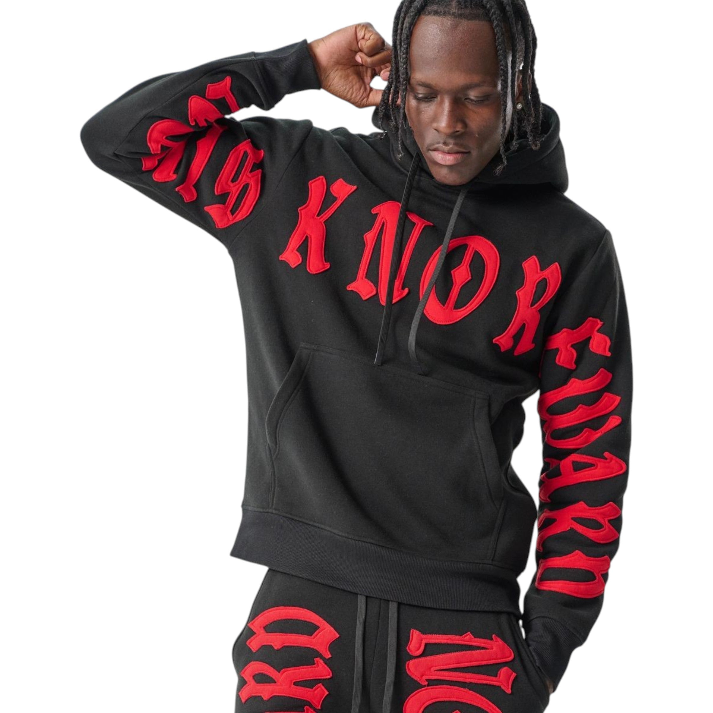 Person wearing a black hoodie and pants with red text on a white background Spark 'No Risk No Reward' Hoodie (Black/Red) S5201