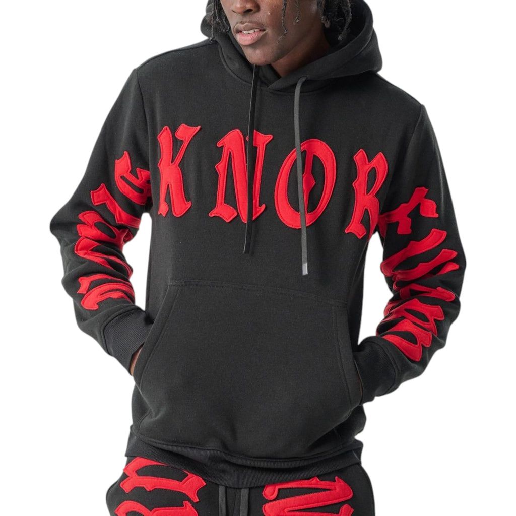 Black hoodie with red text worn by a person on a white background