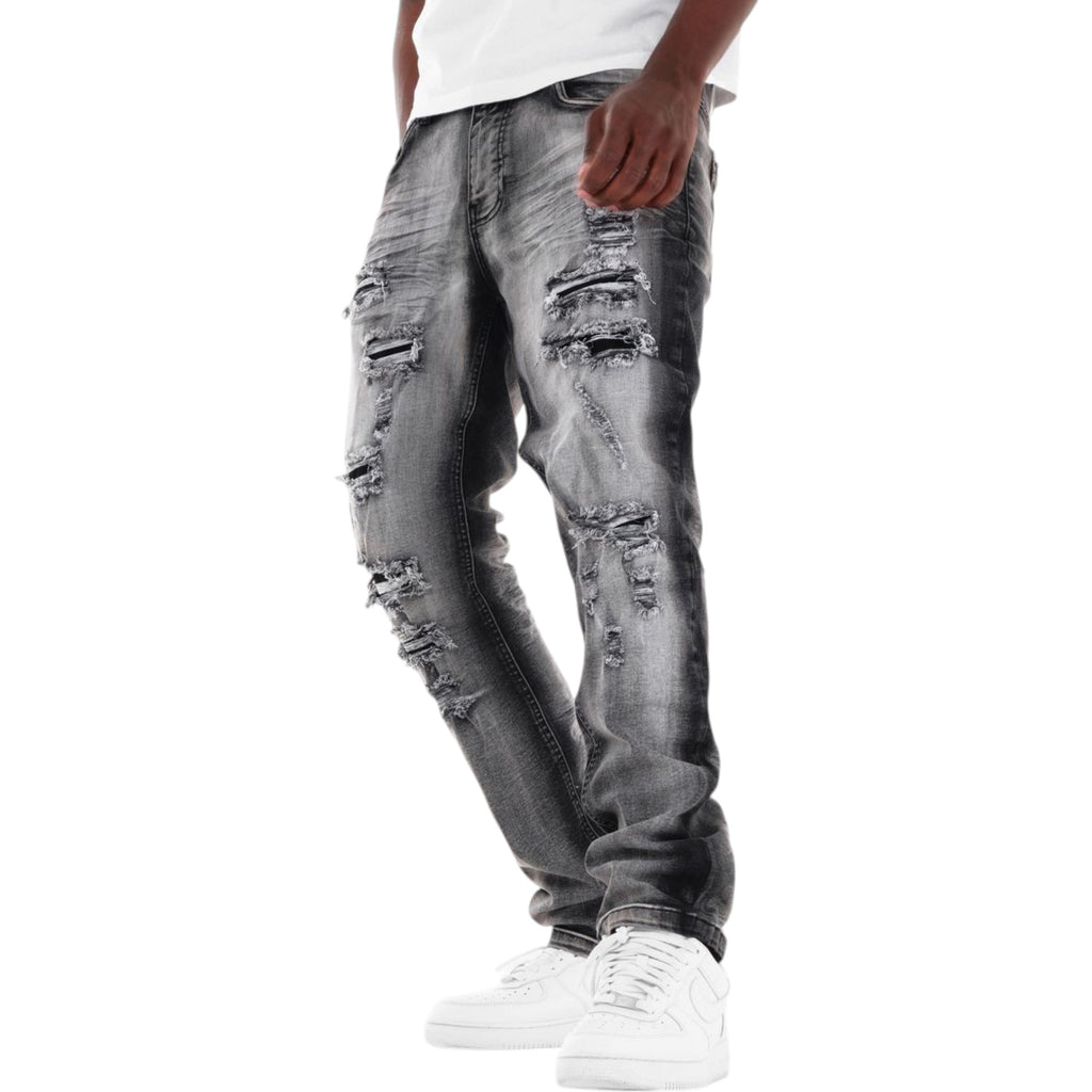 Ripped black gray jeans worn by a person on a white background slim straight fit jean with rips